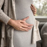 Image of a woman's pregnant belly being held her and her partner